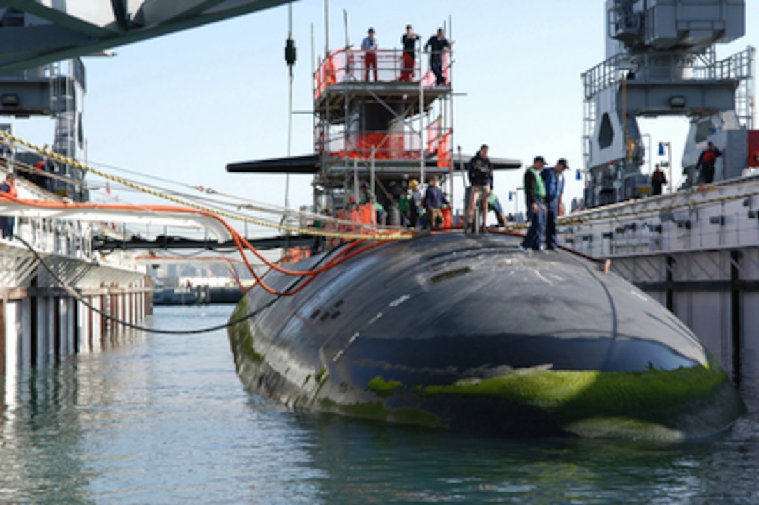 The Los Angeles-class fast-attack nuclear submarine USS Helena (SSN 725) is guided and pulled by mooring lines into the floating dry dock Arco (ARDM 5) at Naval Base Point Loma, Calif., on Jan. 10, 2005. The crews of Arco and Helena along with civilian contractors will perform scheduled maintenance procedures on the submarine. 