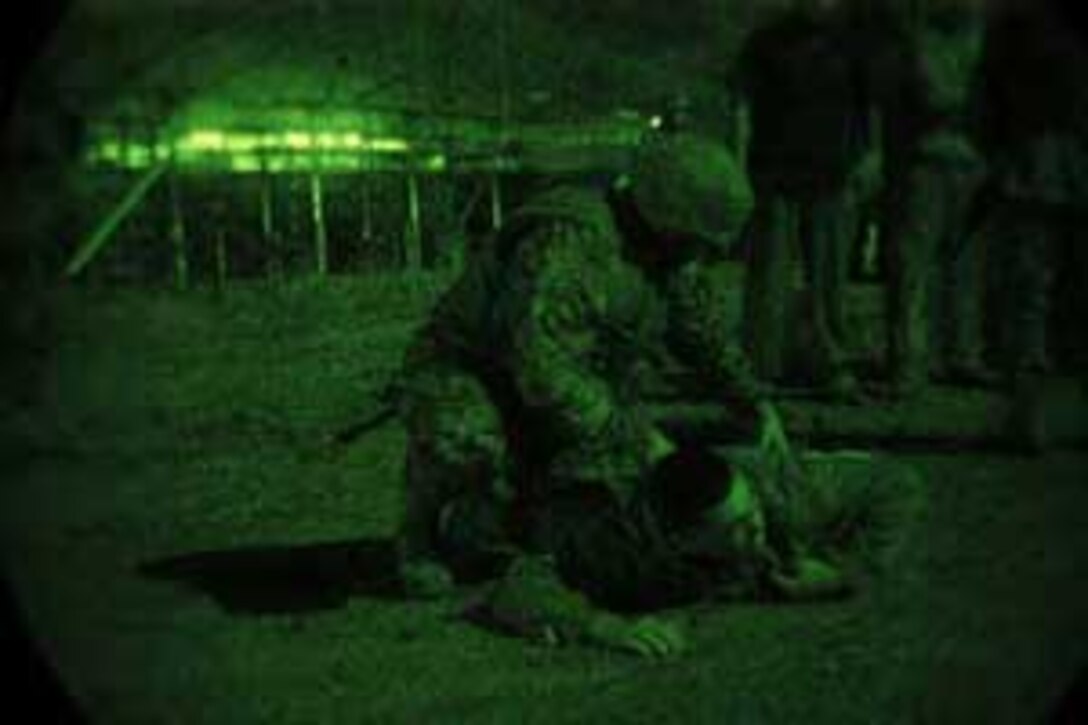 CAMP PENDLETON, Calif. (Apr. 11, 2006) --    A Marine from 5th Battalion 11th Marine Regiment searches an evacuee during the processing portion of a Non-combatant Evacuation Operation Exercise at 52 area Combat Town here. Marines from 5/11 were tasked with providing security and processing of the non-combatants during the NEO Exercise in support of the 15th Marine Expeditionary Unit during its MEUEX. MEUEX is a series of exercises designed to prepare the 15th MEU for its planned deployment this fall.