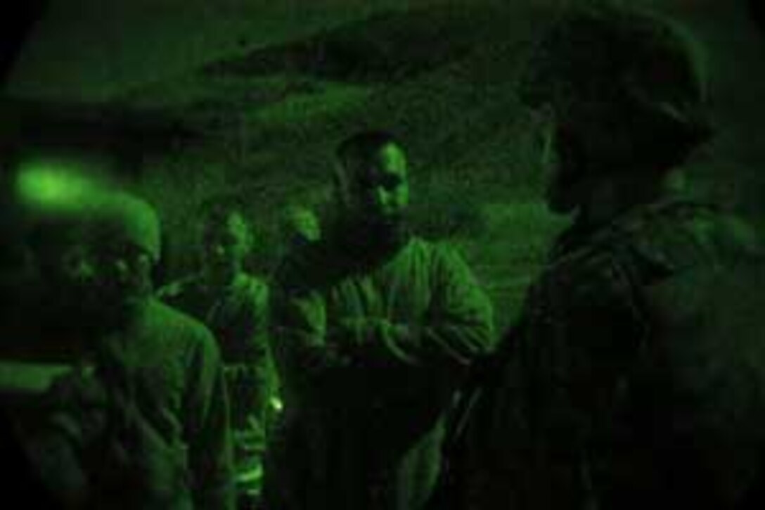 CAMP PENDLETON, Calif. (Apr. 11, 2006) --    A Marine from 5th Battalion 11th Marine Regiment screens an evacuee during the processing portion of a Non-combatant Evacuation Operation Exercise at 52 area Combat Town here. Marines from 5/11 were tasked with providing security and processing of the non-combatants during the NEO Exercise in support of the 15th Marine Expeditionary Unit during its MEUEX. MEUEX is a series of exercises designed to prepare the 15th MEU for its planned deployment this fall.