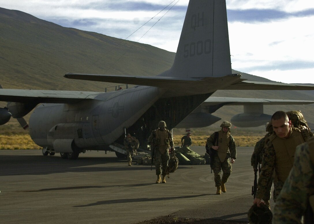MARINE CORPS BASE HAWAII, KANEOHE BAY (Jan. 11, 2006) -- Under the shadow of the Mauna Kea mountain, a KC-130T Hercules cargo plane with Marine Aerial Refueler Transport Squadron 234, Marine Aircraft Group 41, unload a group of Marines preparing to take part in a Hawaii Combined Arms Exercise taking place this month in Pohakuloa Training Area, Hawaii. Meaning "white mountain," Mauna Kea is just one of the mountains near PTA where the Marines will train in maneuvers and combat tactics. Based out of the Naval Air Station Joint Reserve Base-Fort Worth, Texas, the 'Rangers' are serving as a force provider to MAG-24 who is operating as the Air Combat Element in the exercise. Other units participating in the exercise include Combat Service Support Group 3 and the 3rd Marine Regiment.  (U.S. Marine Corps photo by Sgt. Joel A. Chaverri)