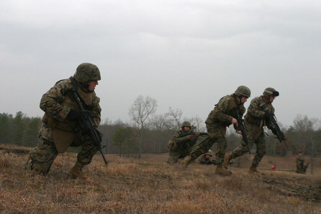 Marines from Alpha Company, Battalion Landing Team, 1st Battalion 8th Marines do a squad assault on a hill at Fort A.P. Hill V.A., on January 11, 2006. The BLT is the ground combat element of the 24th Marine Expeditionary Unit. Marines of Alpha Co. are using there time on Ft. A.P. Hill to sharpen there fire and movement skills on the installation's abundant variety of courses it has to offer. . (U.S. Marine Corps Photo by Lance Corporal Joshua Lujan)::n::::n::::n::