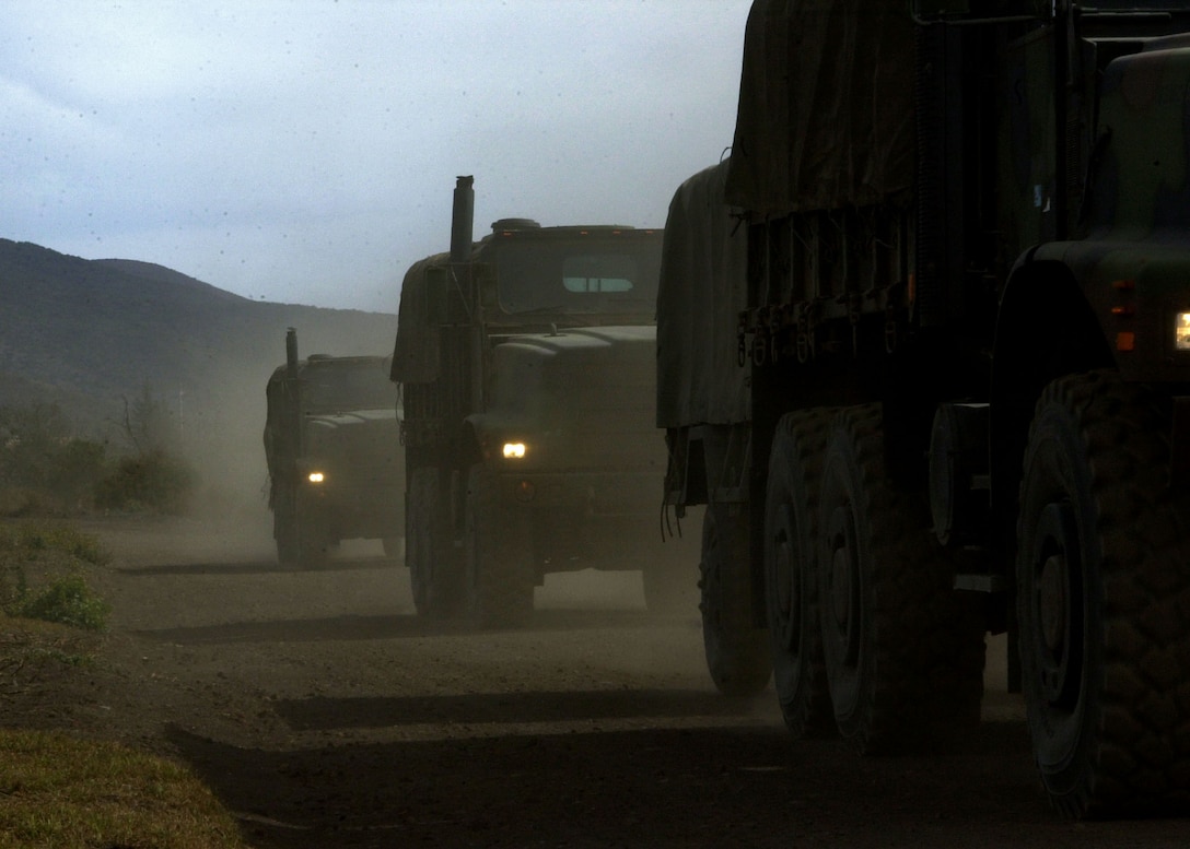MARINE CORPS BASE HAWAII, KANEOHE BAY (Jan. 11, 2006) -- Beneath the Mauna Kea mountain, seven-ton trucks transport Marines preparing to take part in a Hawaii Combined Arms Exercise taking place this month in Pohakuloa Training Area, Hawaii. Meaning "white mountain," Mauna Kea is just one of the mountains near PTA where the Marines will train in maneuvers and combat tactics. Units participating in the exercise include Marine Aircraft Group 41, Marine Aircraft Group 24, Combat Service Support Group 3, and the 3rd Marine Regiment. (U.S. Marine Corps photo by Sgt. Joel A. Chaverri)