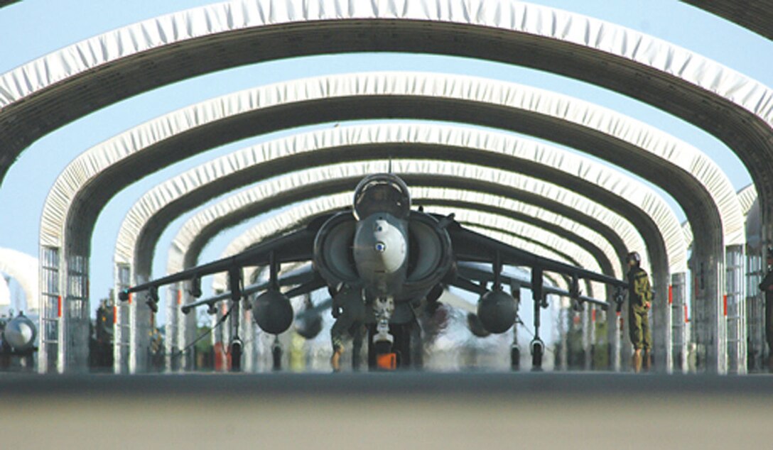 Marines from Marine Attack Squadron 311 hustle to ensure the AV-8B Harrier is ready for take off here from the station runway July 11. VMA-311 sent two AV-8B Harriers to Iwakuni, Japan, in support of the 31st Marine Expeditionary Unit (Special Operations Capable). The unit set a new record for flying the most combat flight hours by a Harrier squadron with its deployment to Iraq in 2005.