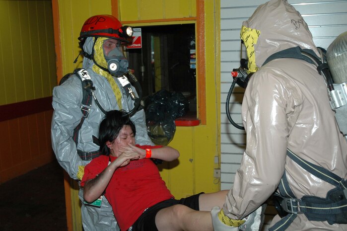 ST. LOUIS--Bravo Company, Chemical Biological Incident Response Force, II Marine Expeditionary Force Marines extract a casualty from a contaminted environment during a simulated chemical attack training evolution here Aug. 11.  The unit's participation in the exercise is part of its ongoing commitment to support local, state and federal first responders with the decontamination and extraction of casualties in the event of a CBRNE (Chemical Biological Radiological Nuclear or High Yield Explosive) attack.