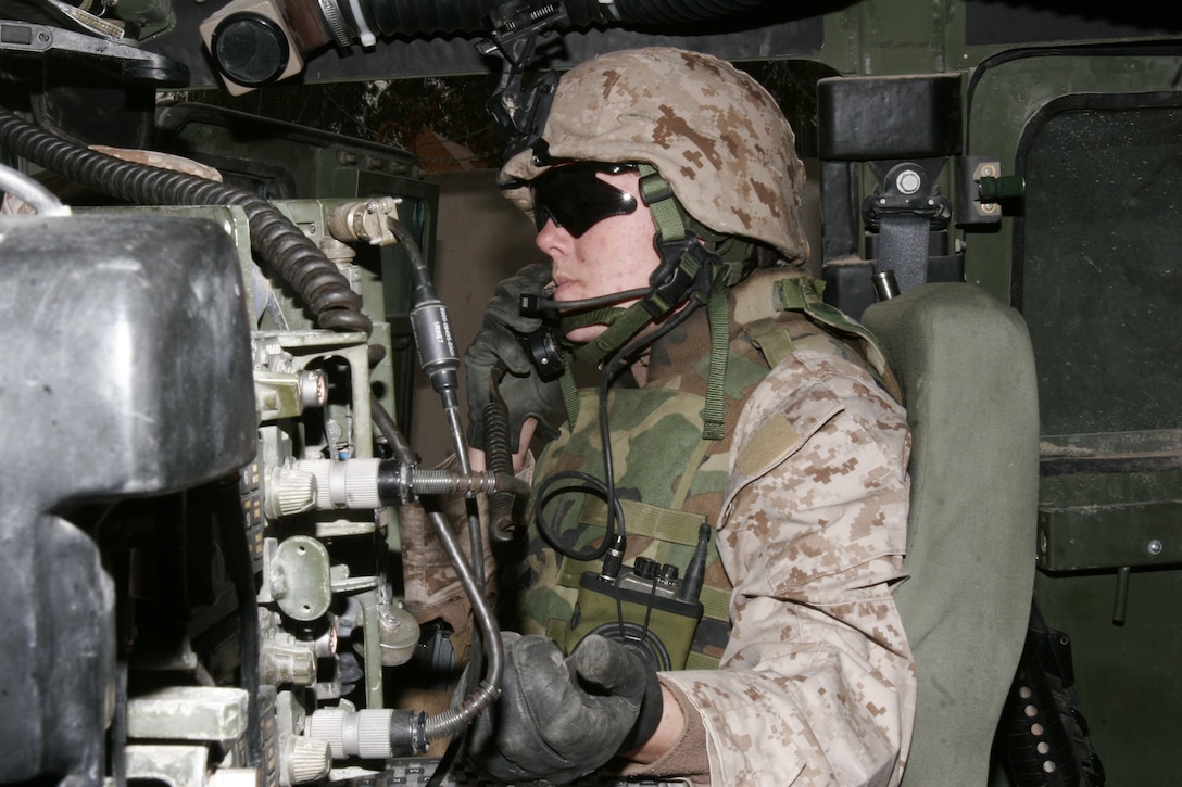 Corporal Tasha M. Monz prepares her equipment before a convoy.  Monz, assigned to Combat Logistics Battalion 8, 2nd Marine Logistics Group (FWD), serves as the battalion commander's radio operator and often finds herself in volatile areas in Iraq.