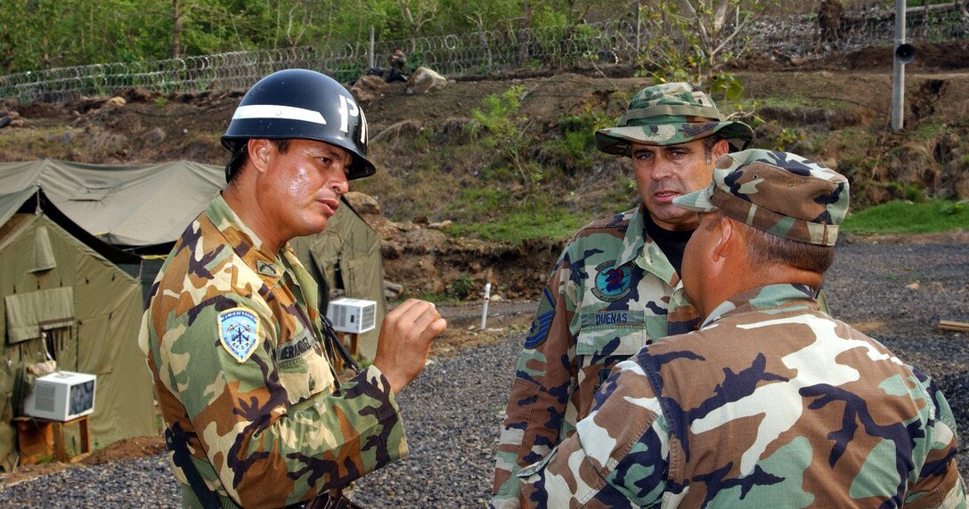 An El Salvadorian Security Forces member speaks with Security Forces members from the 482d Fighter Wing, Homestead ARB, Fla.  The 482d Fighter Wing Civil Engineering Squadron was the lead unit for the humanitarian operation, which saw the construction of two schools and three medical clinics near San Vicente (U.S. Air Force Reserve photo by Lt. Col. Tom Davis).  