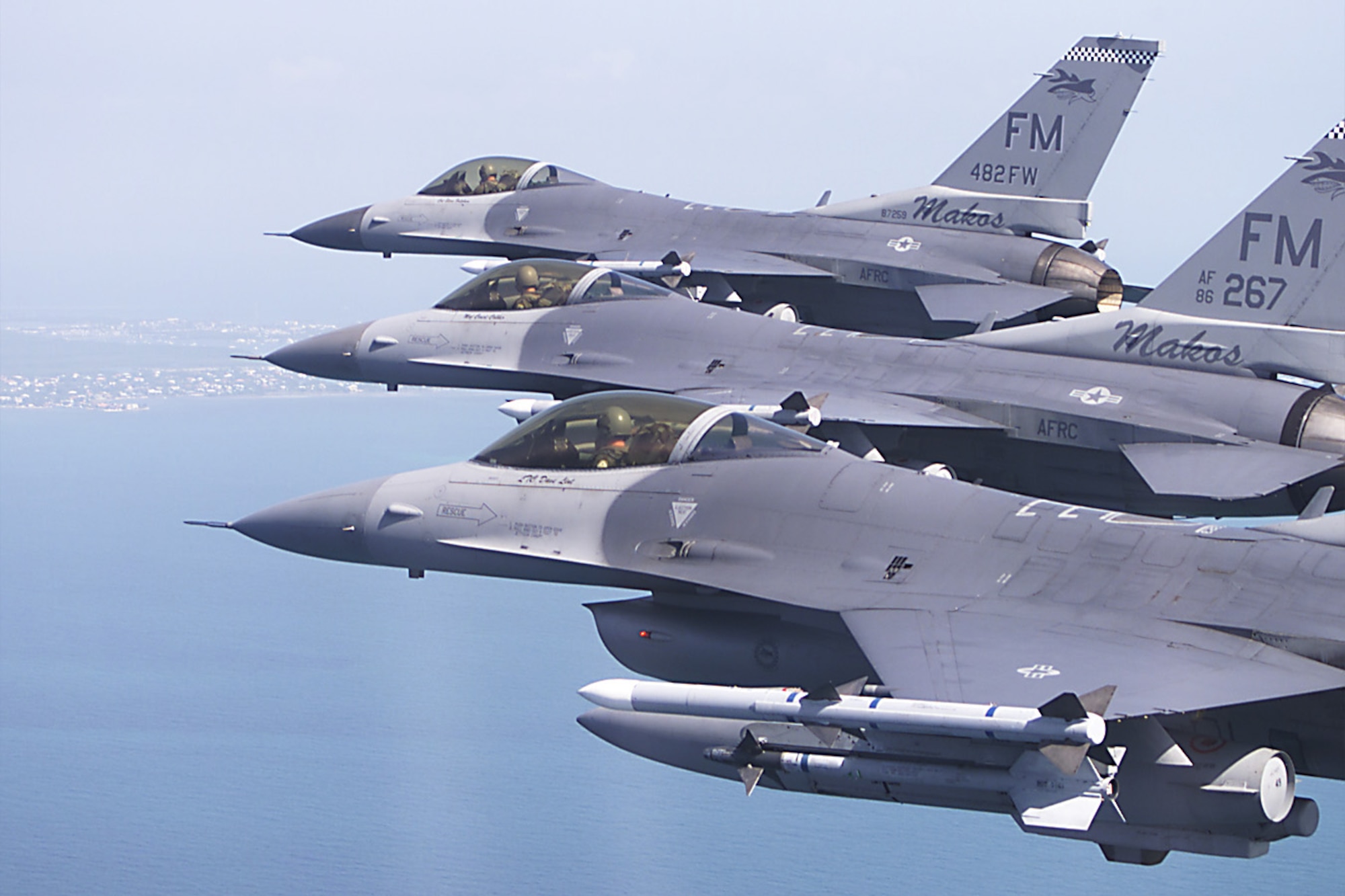 482nd Fighter Wing / 93rd Fighter Squadron closeup of a threeship formation of Lockheed F-16C Fighting Falcons carrying Aim-120 and Aim-9 air-to-air missiles.  The aircraft are based at Homestead Air Reserve Station flying near the Southern Flordia coastline. (Photo by: MSgt Joe Cupido, 4th Combat Camera)