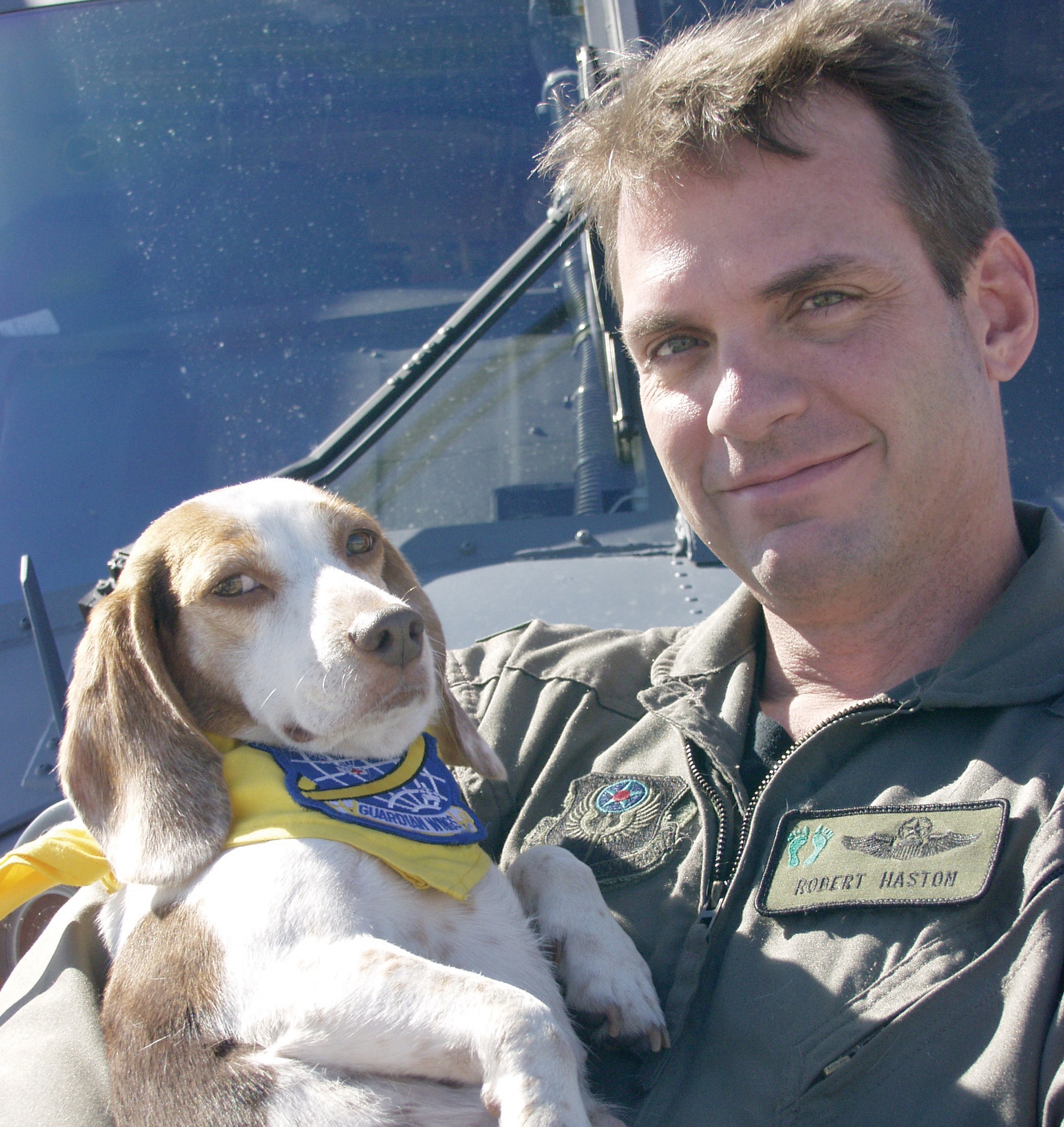 PATRICK AIR FORCE BASE, Fla. - Maj. Robert Haston, a 301st Rescue Squadron helicopter pilot, holds fellow rescue crewmember Katrina after reuniting in December. The courageous canine assisted pararescuemen and helicopter crews during Hurricane Katrina rescue operations in New Orleans. (U.S. Air Force photo by Senior Airman Heather L. Kelly)        