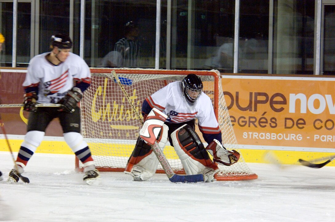 STRASBURG, France (AFPN) -- Staff Sgt. Adam Woolley captures a puck during a hockey game in eastern France. The Ramstein Rams hockey team held on to win 6-5 against the Strasburg Gryphons despite a late game push. Sergeant Woolley is part of the Kaiserslautern Military Community, which has a hockey team made up of 30 players in different skill levels varying from semi-pro to beginners. Sergeant Woolley is with the USAFE's regional supply squadron at Sembach Air Base, Germany. (U.S. Air Force photo by Master Sgt. John E. Lasky)