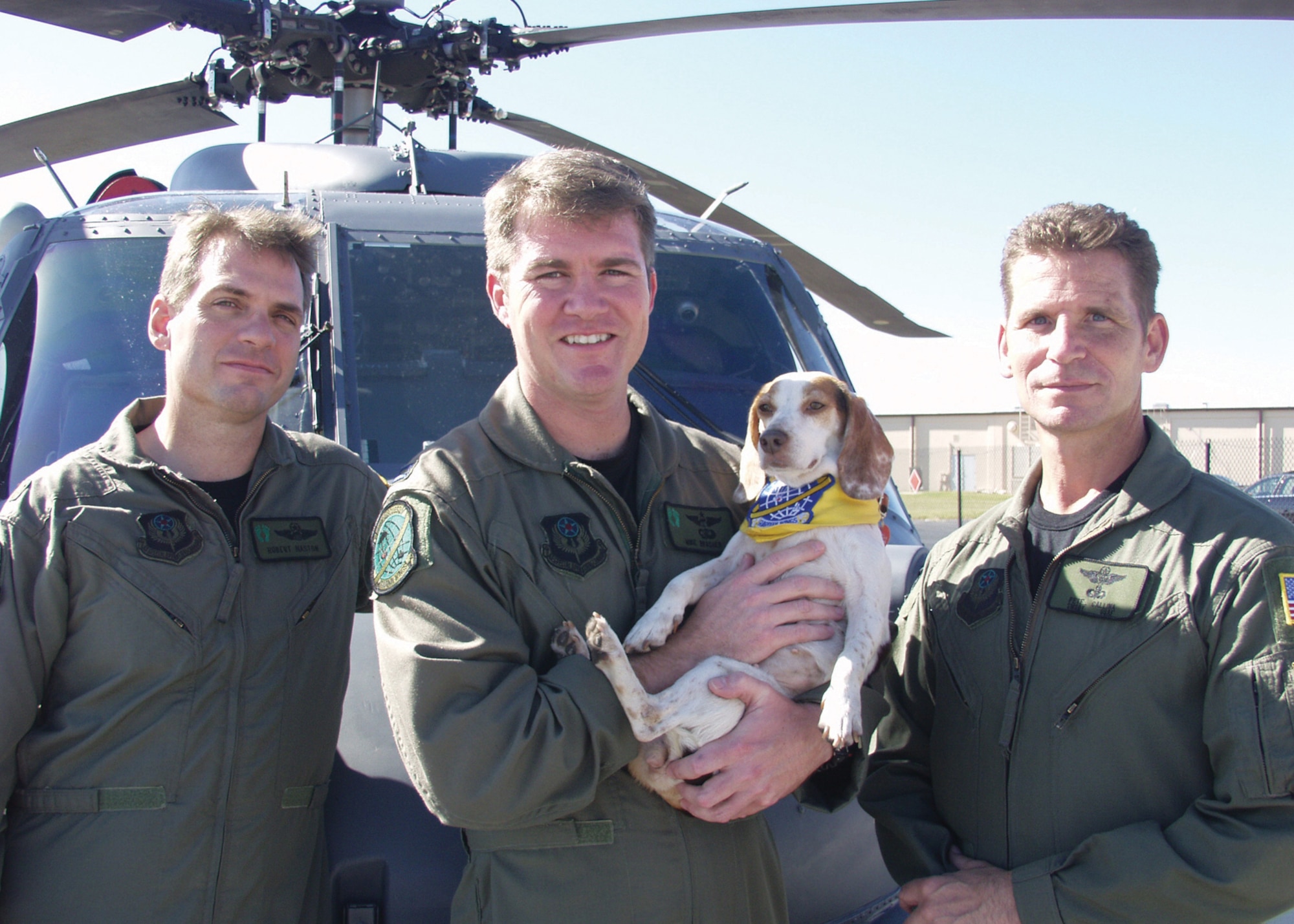 PATRICK AIR FORCE BASE, Fla.- 920th Rescue Wing members Maj. Robert Haston (left), Capt. Michael Brasher (center), and Senior Master Sgt. Pete Callina (right) pose with the brave beagle that aided their rescue efforts in New Orleans during Hurricane Katrina operations. Renamed "Katrina", the canine was reunited with the crew after Captain Brasher and his wife conducted their own search and rescue mission. (U.S. Air Force photo by Senior Airman Heather L. Kelly)