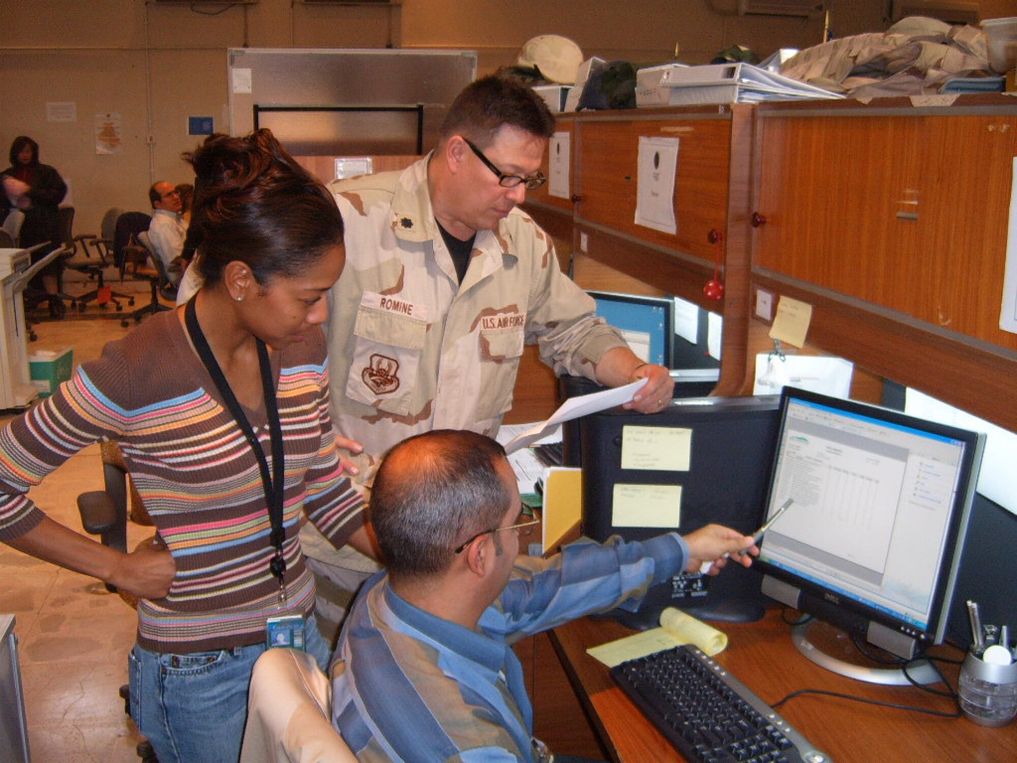 Lt. Col. Ralph Romine, deputy commander of Air Force Reserve Command's 910th Mission Support Group, works with employees of the U.S. Army Corps of Engineers and local civilians in Baghdad as part of the continuing rebuilding effort in Iraq.  U.S. Air Force courtesy photo.