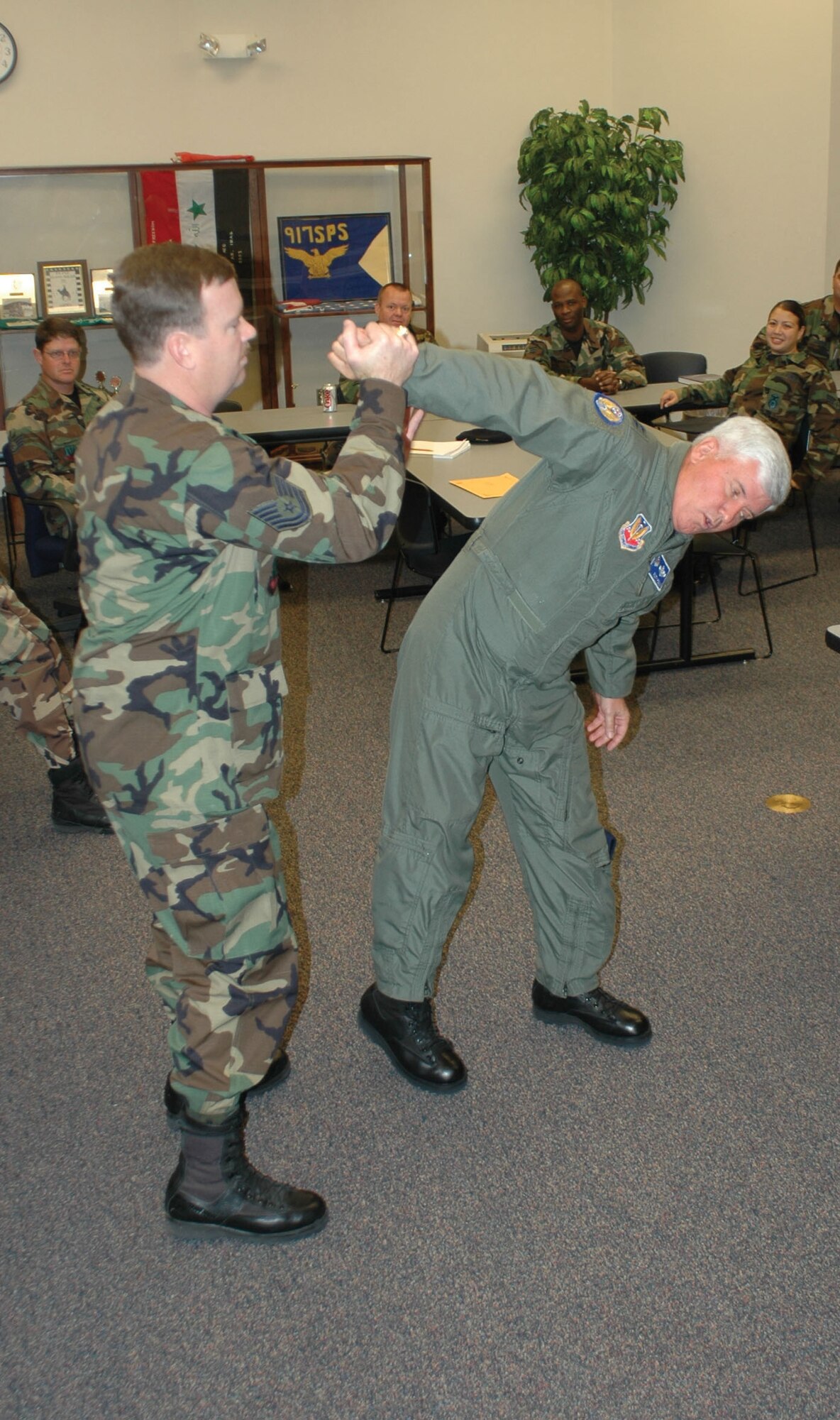 Tech. Sgt. William Rogers, 917th Security Forces Squadron fire team leader, practices a wrist lock and a take-down manuever used to subdue a suspect on General Poulin. (USAF Photo by Tech. Sgt. Sherri Savant)