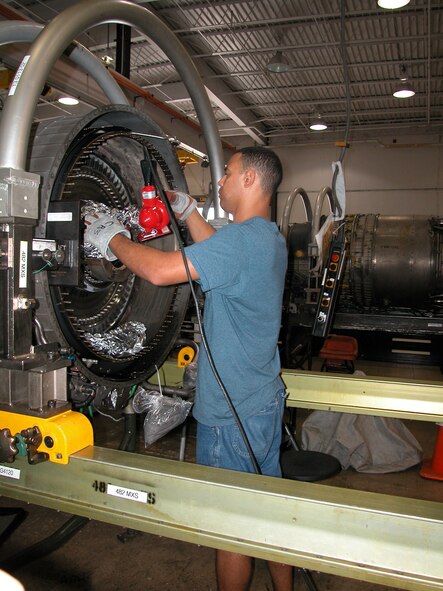 An aerospace propulsion specialist assigned to the 482nd Fighter Wing's engine shop performs maintenance work on the engine of an F-16 Fighting Falcon 'Mako'.  This type of scheduled maintenance, called 'Phase' is performed on F-16 engines every 200 flight hours (U.S. Air Force Reserve photo by Senior Airman Denise Quasius).