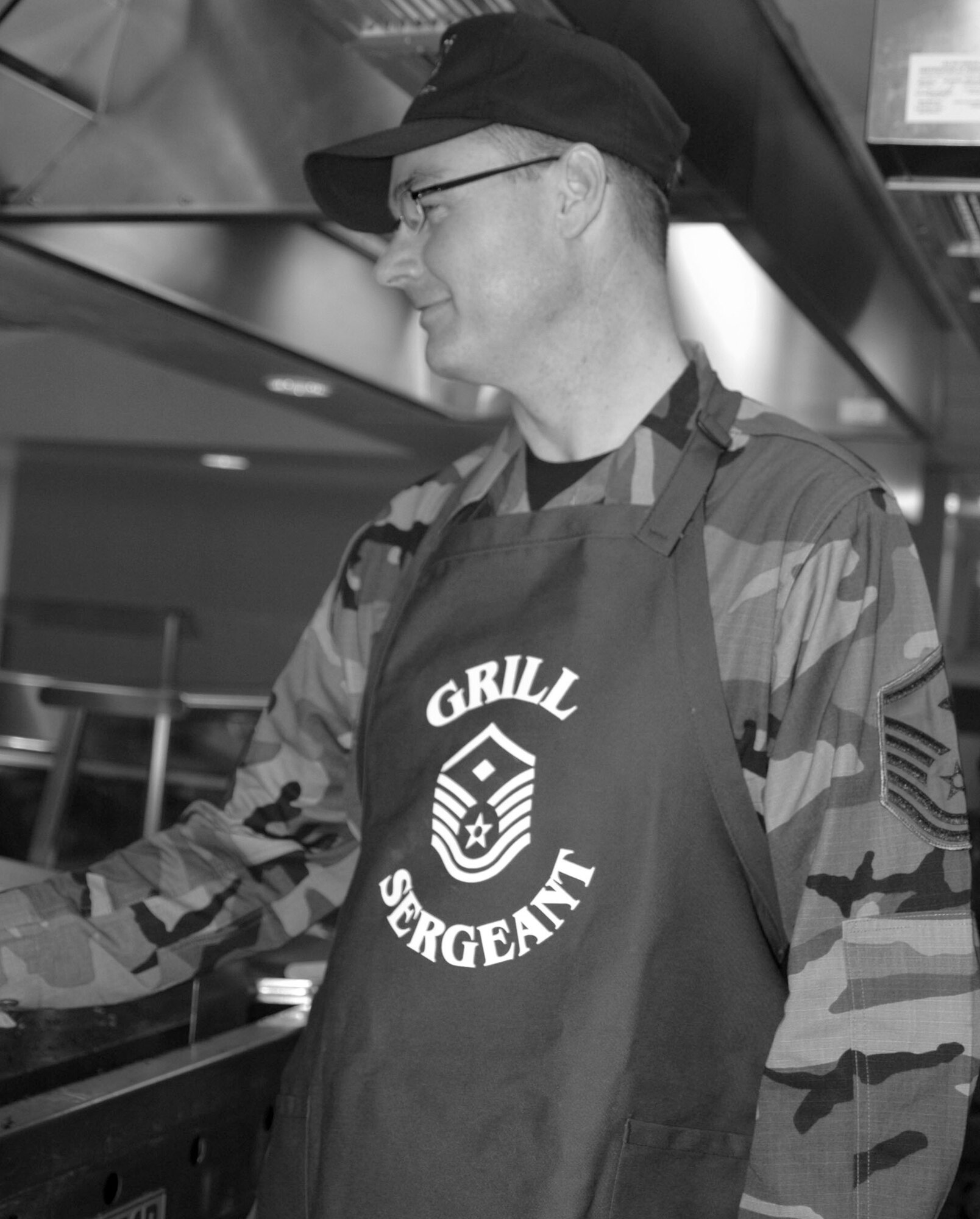 Msgt. Christopher Lee, 917th MOS first sergeant, flips burgers in the dining facility furing Services Appreciation Day. (Photo by Staff Sgt. Ebony Nichols)