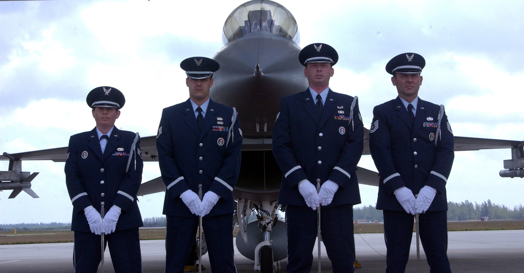 Homestead ARB, Fla. -- members of the Homestead Air Reserve Base Honor Guard stand with an F-16 Mako from the 93d Fighter Squadron.  From left to right:  Staff Sgt. Natasha Jamass, Staff Sgt. Luis Pacheco, Staff Sgt. Ryan Ayers and Technical Sgt. Francisco Navarro.  (U.S. Air Force Reserve photo by Jake Shaw).