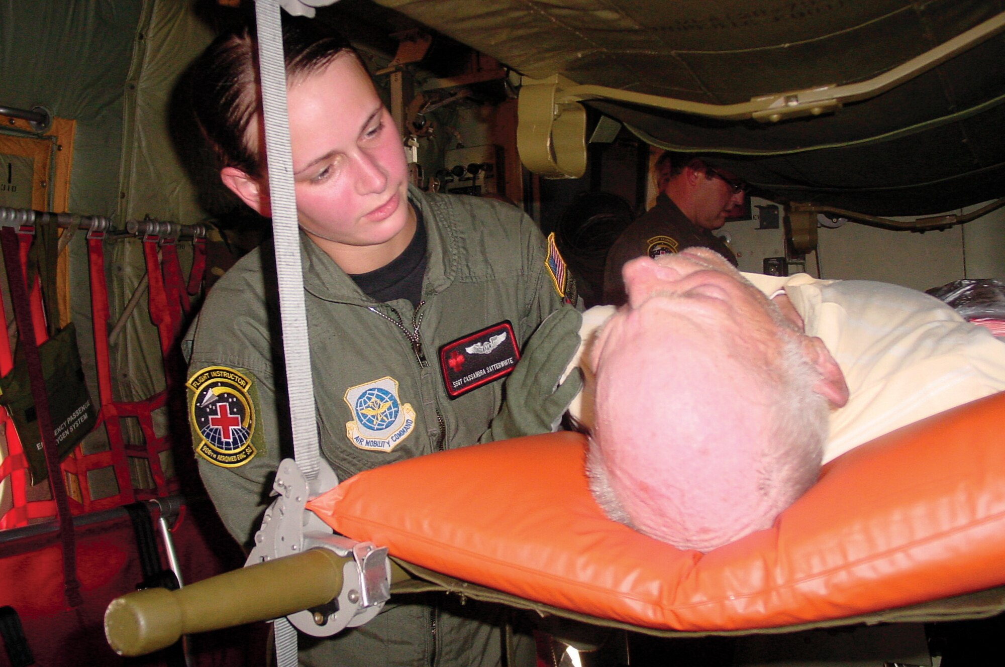 Air Force Reserve aeromedical services technician Staff Sgt. Cassandra Satterwhite, 908th Aeromedical Evacuation Squadron, provides comfort to a Gulf Coast  evacuee aboard a C-130 Hercules from the 357th Airlift Squadron, Maxwell AFB,, Ala. Aug. 31.

Photo by Maj. Jerry Lobb