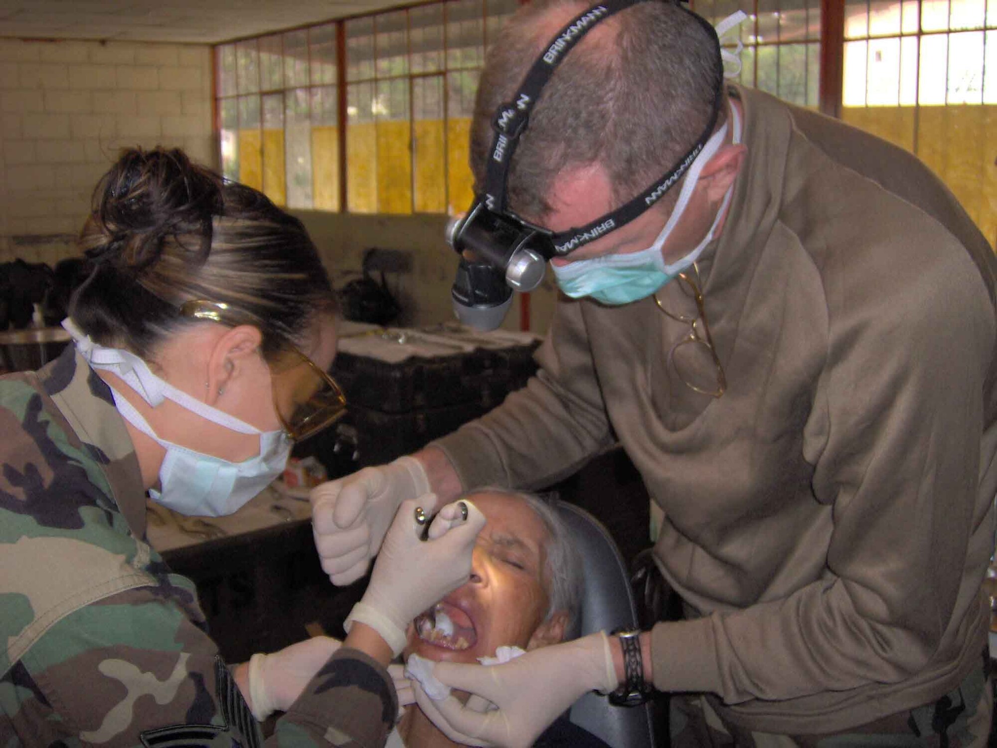 Tech. Sgt. Kristie Wever, 944th Medical Squadron, and Army Capt. Glen Lance, 94th Medical Unit, extract a tooth from an Ecuadorian. Sergeant Wever, a reservist at Luke Air Force Base, Ariz., volunteered to travel to Ecuador with the 94th Medical Unit from Seagoville, Texas, as part of a Medical Readiness Training Exercise.