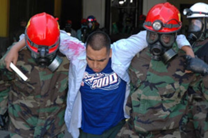 LANDOVER, Md.-Military personnel with the Chemical Biological Incident Response Force Company B focus on their mission of "closing with and saving life" during a simulated weapons of mass destruction attack at the Landover Metro Training Facility May 12.  During the evolution the Marines and Sailors are challenged to keep full situational awareness as different threats surface including, but not limited to, secondary improvised explosive devices and hostile casualties.