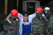 LANDOVER, Md.-Military personnel with the Chemical Biological Incident Response Force Company B focus on their mission of "closing with and saving life" during a simulated weapons of mass destruction attack at the Landover Metro Training Facility May 12.  During the evolution the Marines and Sailors are challenged to keep full situational awareness as different threats surface including, but not limited to, secondary improvised explosive devices and hostile casualties.