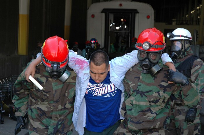 LANDOVER, Md.-Military personnel with the Chemical Biological Incident Response Force Company B focus on their mission of "closing with and saving life" during a simulated weapons of mass destruction attack at the Landover Metro Training Facility May 12.  During the evolution the Marines and Sailors are challenged to keep full situational awareness as different threats surface including, but not limited to, secondary improvised explosive devices and hostile casualties.