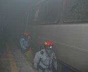LANDOVER, Md.-The Chemical Biological Incident Response Force Company B enter the "unknown" during a simulated weapons of mass destruction attack at the Landover Metro Training Facility May 12.  According to 1st Sgt. Brian Taylor, Company B First Sergeant, CBIRF, "To understand the operation as a whole one must think of it as 'organized chaos.'"  "What this means," explains Taylor, "is that there is so much going on, it [the rescue mission] looks chaotic but in all reality the Marines and Sailors within the chaos fully understand their jobs and how to make this work with the other Marines and Sailors within the crisis area."