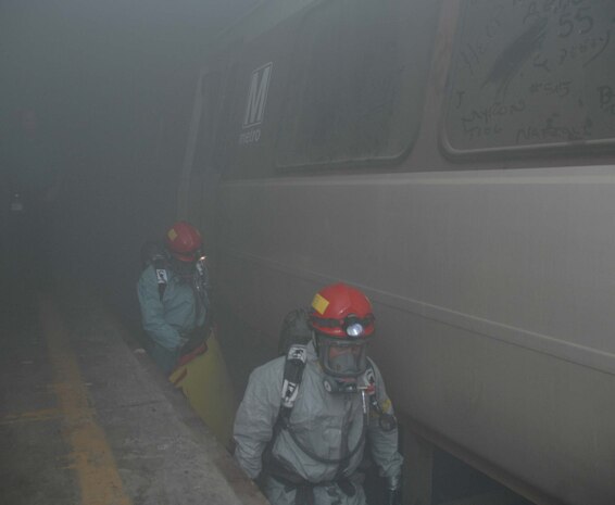 LANDOVER, Md.-The Chemical Biological Incident Response Force Company B enter the "unknown" during a simulated weapons of mass destruction attack at the Landover Metro Training Facility May 12.  According to 1st Sgt. Brian Taylor, Company B First Sergeant, CBIRF, "To understand the operation as a whole one must think of it as 'organized chaos.'"  "What this means," explains Taylor, "is that there is so much going on, it [the rescue mission] looks chaotic but in all reality the Marines and Sailors within the chaos fully understand their jobs and how to make this work with the other Marines and Sailors within the crisis area."