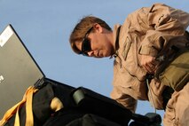 Staff Sgt. Christine Weber programs a Sherpa 1200 series parachute system at Al Asad, Iraq, April 13. Weber is an assistant air delivery project officer with Infantry Weapons Section, Raids and Reconnaissance, Marine Corps Systems Command. She is a native of Charlotte, N.C.