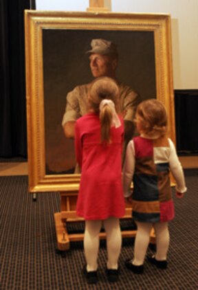 MARINE BARRACKS WASHINGTON ? Two attendees of the passage of command reception held on Nov. 13 gaze at a portrait of the 33rd Commandant of the Marine Corps Gen. Michael W. Hagee. The portrait will be displayed in the Commandant?s Quarters. A copy will also be present inside the Pentagon along Commandant?s Corridor.