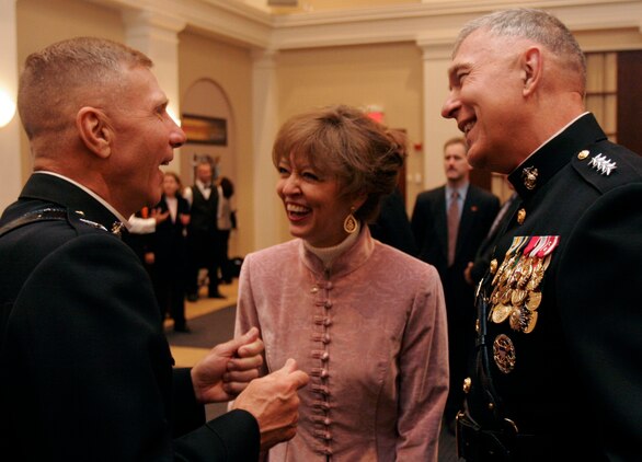 MARINE BARRACKS WASHINGTON ? The 34th Commandant of the Marine Corps Gen. James T. Conway and his wife Annette interact with Conway?s predecessor, Gen. Michael W. Hagee, after an award ceremony Nov. 13. During the ceremony, Hagee?s commandant portrait was unveiled by Secretary of Defense Donald H. Rumsfeld.