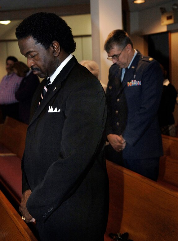 LACKLAND AIR FORCE BASE, Texas (AFPN) -- Eugene Turner (left) and Maj. Robert Wido pray during the Dr. Martin Luther King, Jr. 2006 Commemorative Service at the Freedom Chapel here. Mr. Turner is the base's human resource training officer and Major Wido is the 37th Training Wing's deputy wing chaplain. (U.S. Air Force photo by Tech. Sgt Larry A. Simmons)