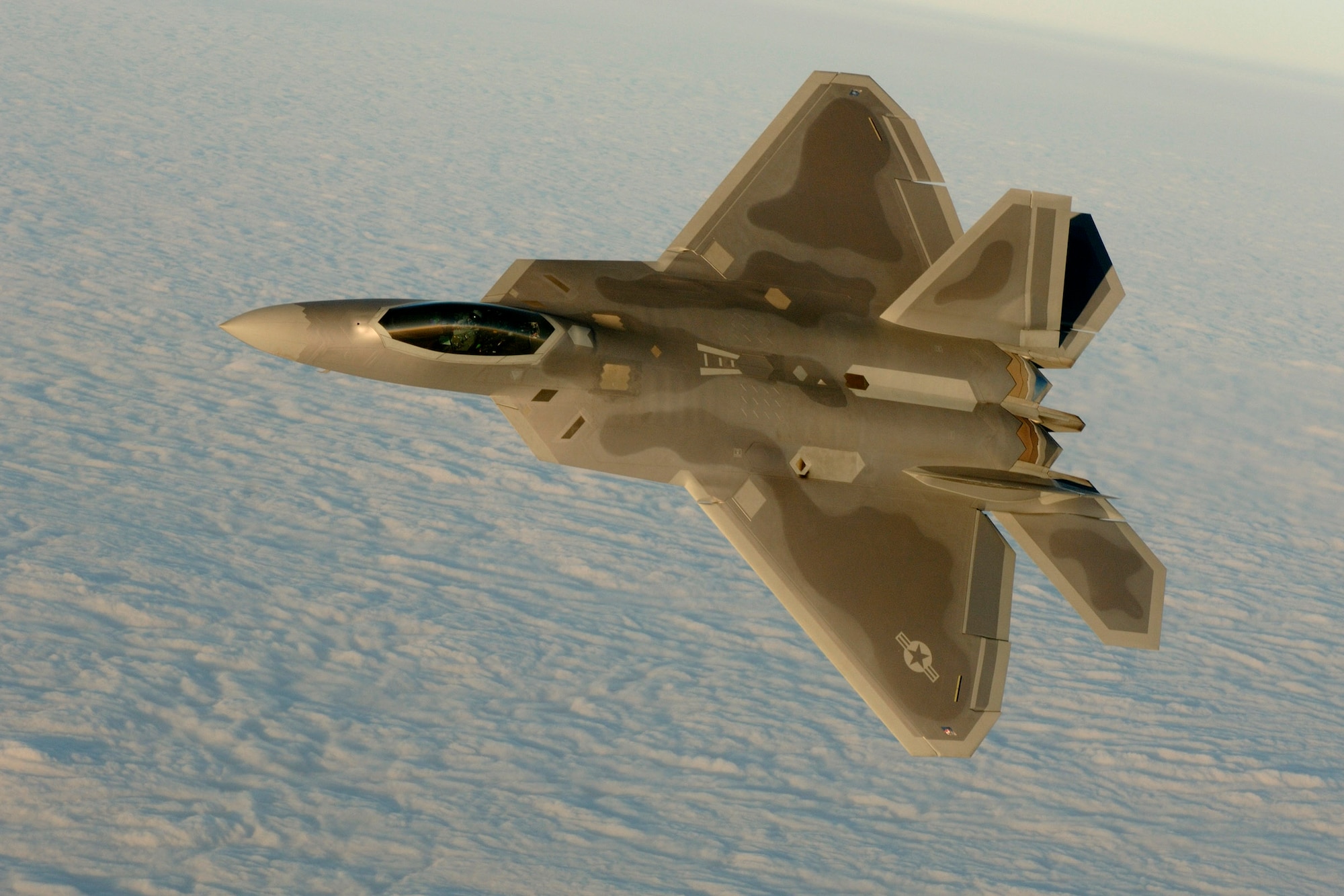 OVER THE ATLANTIC OCEAN (AFPN) -- Capt. Chris Batterton aggressively banks his F-22A Raptor during a basic fighting maneuver training mission off the Virginia coast last week. The captain is with the 27th Fighter Squadron, the Air Force's first unit to fly the Raptor. The 1st Fighter Wing declared initial operational capability last month, making the Air Force's fifth generation fighter ready to fight. (U. S. Air Force Photo by TSgt Ben Bloker)