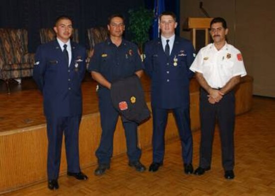 (From left to right) Airman 1st Class Eric Munana, 898th Munitions Squadron; Captain Mark Chavez of the Albuquerque Fire Department; Senior Airman Jonathon Calhoun, 898th Munitions Squadron; and Chief Robert Ortega from the AFD after the medal ceremony where Airmen Calhoun and Munana received Airman's Medals.  The Airmen were given medals after helping Captain Chavez save the lives of a disabled woman and her daughter in an apartment fire in Albuquerque, N.M. (Air Force Photo by Todd Berenger)
