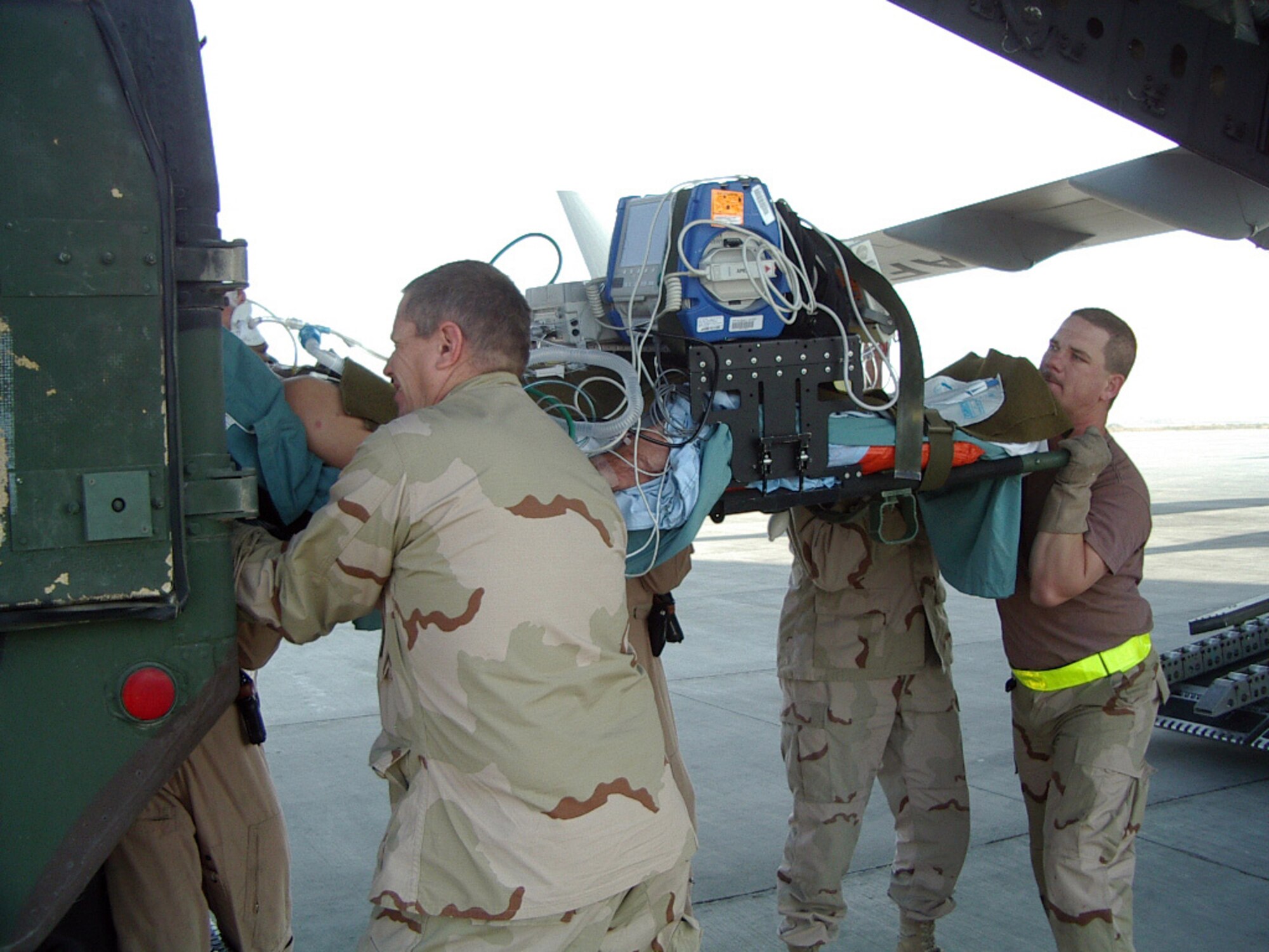 BAGRAM AIR BASE, Afghanistan - Master Sgt. Darrell Ford, right, and other Airmen on his team help transfer a patient from an ambulance to a C-17 Globemaster III. Since September, Airmen of the 455th Expeditionary Operations Group Aeromedical Evacuation Flight have flown more than 80 missions and evacuated more than 300 patients to hospitals and healthcare facilities elsewhere in Afghanistan and as far away as Germany. Sergeant Ford, who's from Plant City, Fla., is deployed here from MacDill Air Force Base, Fla. (U.S. Air Force photo by Master Sgt. David Baker)