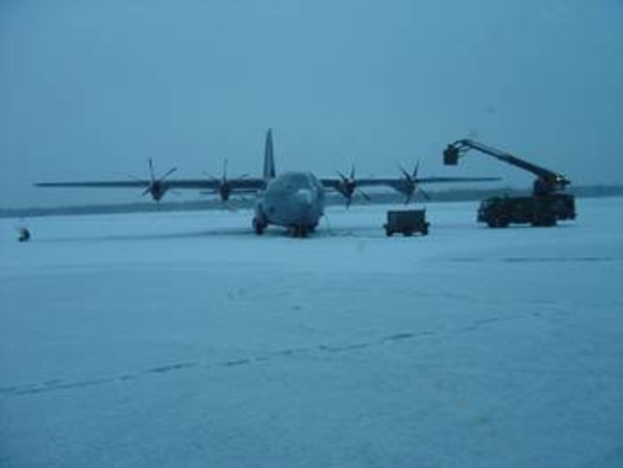 A C-130J is de-iced during Phase 2 Operational Test and Evaluation flight test studies.  The deployment of the C-130J to Eielson was designed to test the aircraft and its avionics' ability to continue its mission through extreme weather conditions. (Air Force photo by 1st Lt. Thomas Harner)
