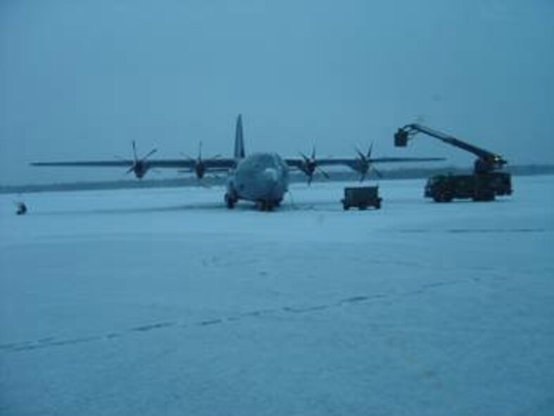 A C-130J is de-iced during Phase 2 Operational Test and Evaluation flight test studies.  The deployment of the C-130J to Eielson was designed to test the aircraft and its avionics' ability to continue its mission through extreme weather conditions. (Air Force photo by 1st Lt. Thomas Harner)

