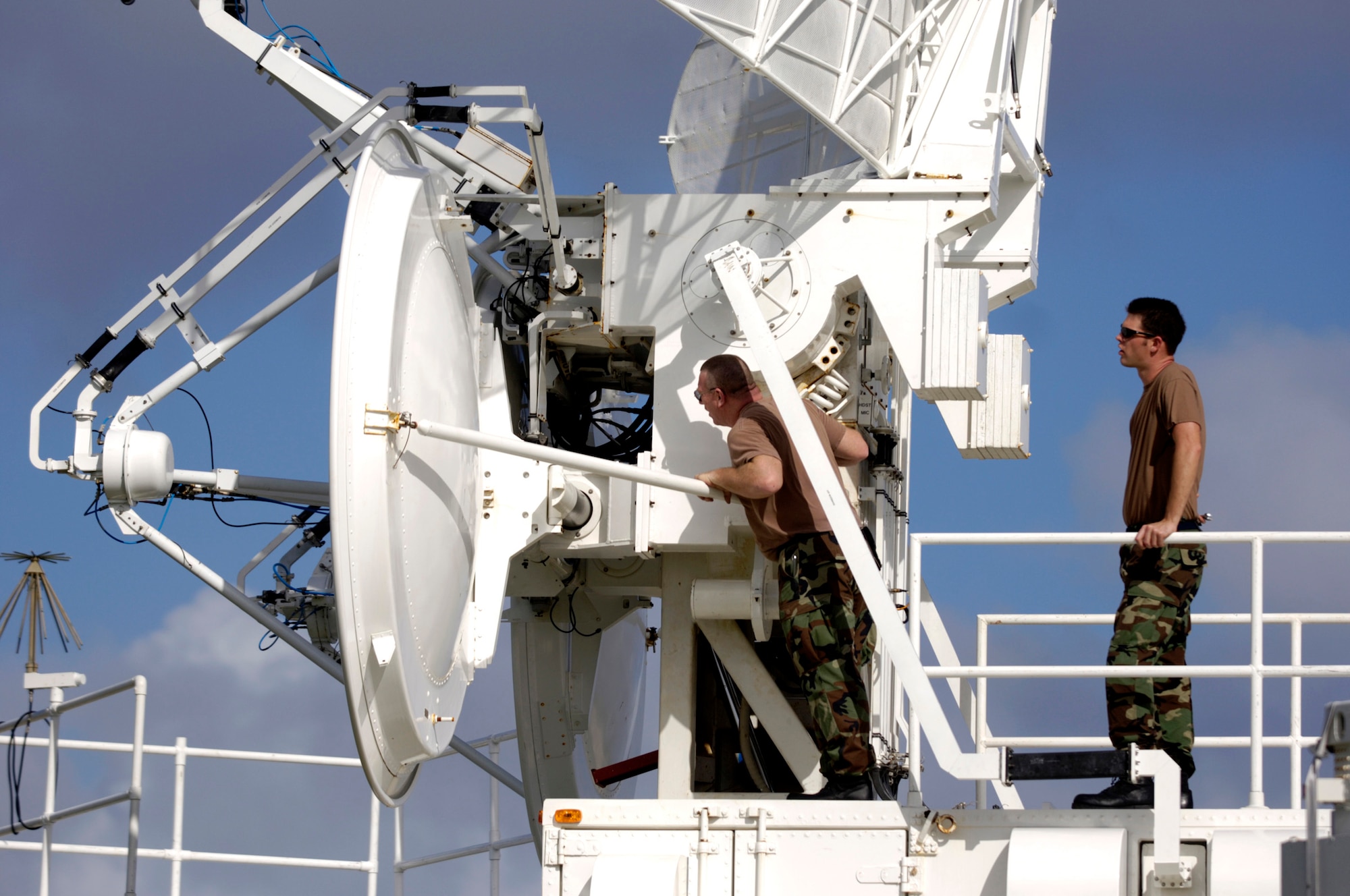 ANDERSEN AIR FORCE BASE, Guam (AFPN) -- Tech. Sgt. John Cumbridge and Staff Sgt. Philip Neussendurfer inspect a radar site here. The site provides electronic threats such as anti-aircraft artillery, surface-to-air-missiles and airborne interceptors for aircraft training. Sergeants Cumbridge and Neussendurfer are radar technicians from the Idaho Air National Guard's 266th Range Squadron. (U.S. Air Force photo by Tech. Sgt. Shane A. Cuomo)