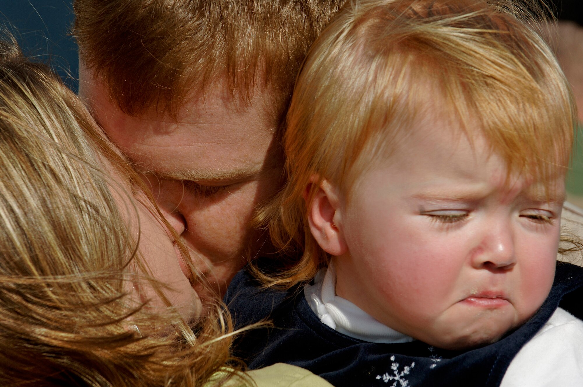 LANGLEY AIR FORCE BASE, Va. (AFPN) -- Staff Sgt. Jon Hendrickson kisses his wife, Cara and daughter, Ashton after returning home from an eight month deployment to Iraq Jan. 9. Sergeant Hendrickson is with the 1st Security Forces Squadron. (U.S. Air Force photo by Airman 1st Class Christopher L. Ingersoll)