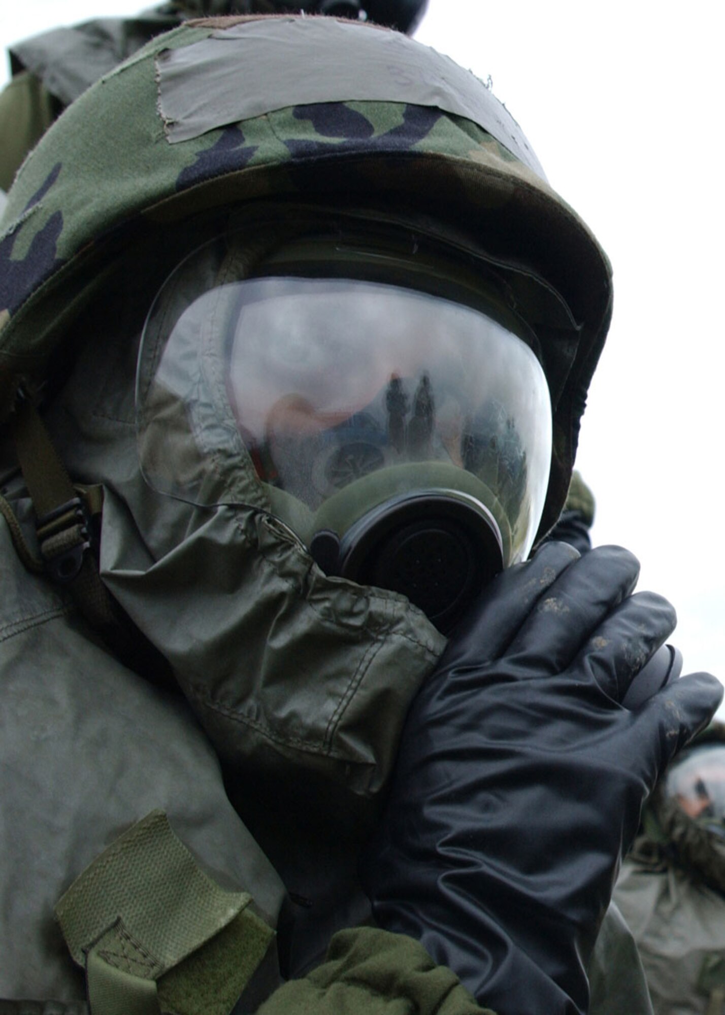 MINOT AIR FORCE BASE, N.D. (ACCNS) -- Airman Elysia Troc, 5th Communications Squadron, adjusts the hood of her gas mask during a base exercise Aug. 9 at Minot Air Force Base, N.D. The exercise simulated a deployed bare base environment to test Airmen's wartime skills. (U.S. Air Force photo by Airman Alicia M. Schnerre)
