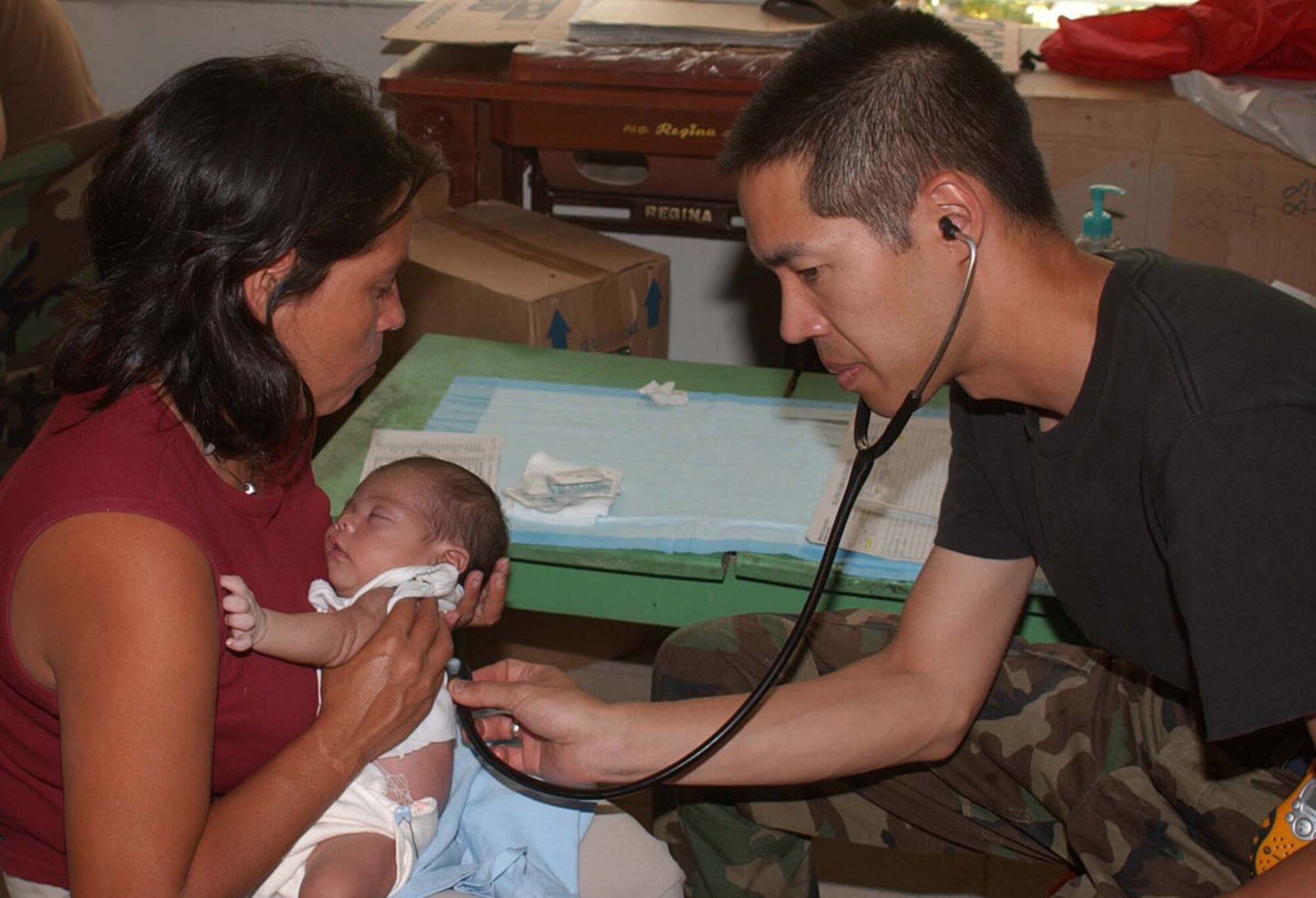 COMAYAGUA, Honduras -- Capt. (Dr.) Douglas Min checks the heartbeat of a 21-day old infant during a medical readiness training exercise in Cuesta de la Virgen, Honduras. The pediatrician from the 355th Medical Operations Squadron at Davis-Monthan AFB, Ariz., was one of 11 Airmen providing various medical services July 19-29 in seven villages near Soto Cano Air Base, home to Joint Task Force-Bravo. (U.S. Air Force Photo by 1st Lt. Anna Siegel)