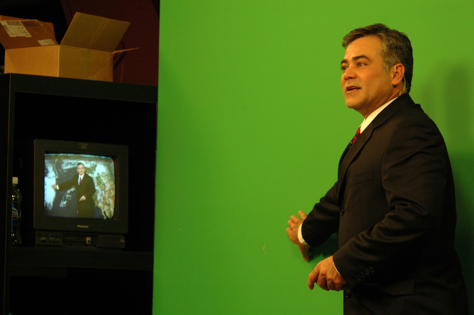 FAIRCHILD AIR FORCE BASE, Wash. (AFPN) -- Retired Master Sgt. Dave Law, broadcast weatherman, KHQ6, uses a green screen to transpose local area weather maps and other weather-related information during a broadcast Jan. 6. He retired from the Air Force in November after serving 23 years as a meteorologist. (U.S. Air Force photo by Staff Sgt. Nathan Gallahan)