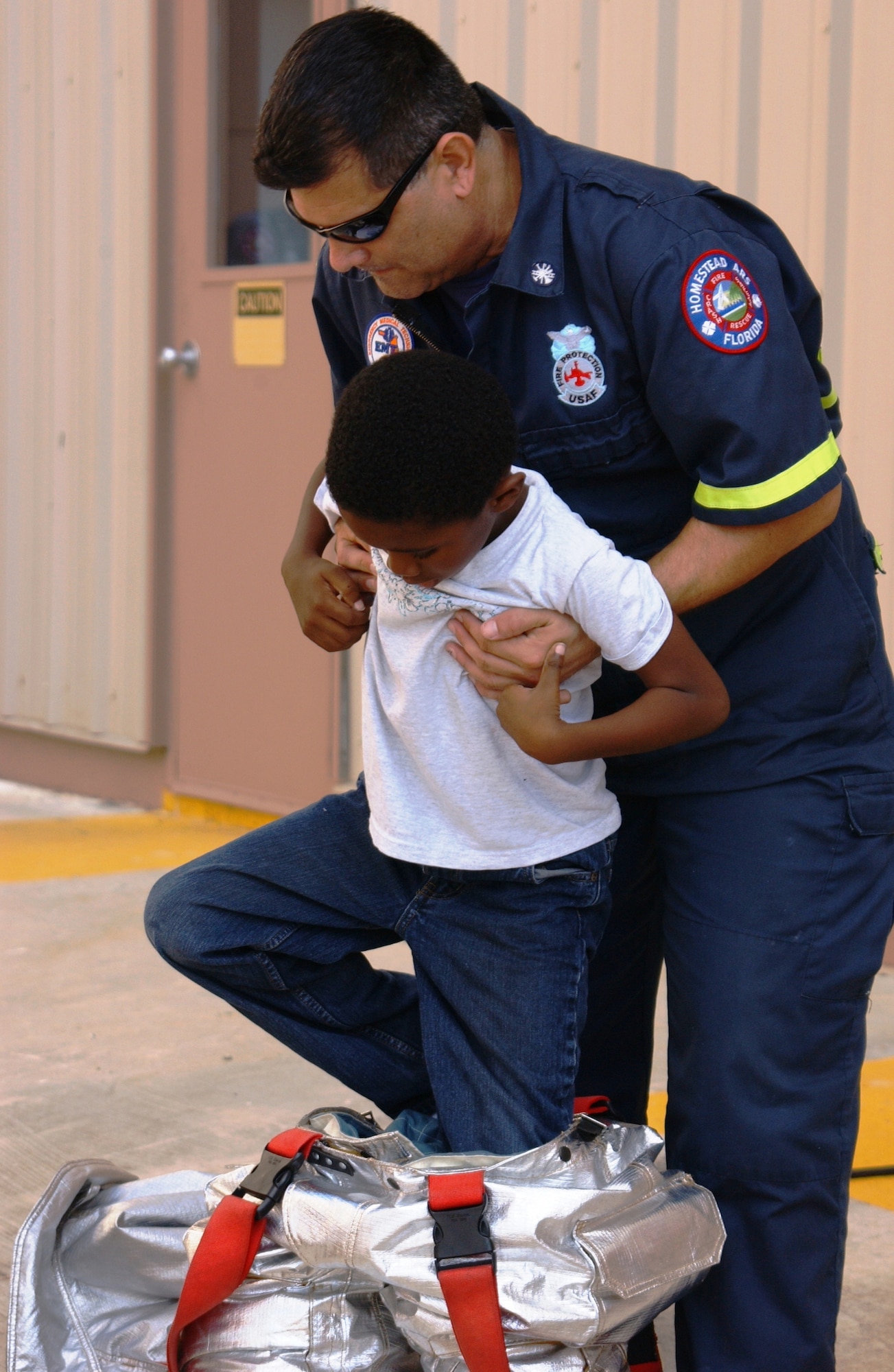 Dave Cavada of the Homestead ARB Fire Department was one of several members on base who gave a special tour to the children that attending the Homestead ARB Family Day on Dec. 4.  Children and families were taken to the 93rd Fighter Squadron to see F-16s, and they also toured the base fire department and the aircraft hangers (U.S. Air Force Reserve photo by Senior Airman Sandra Bueno).                               