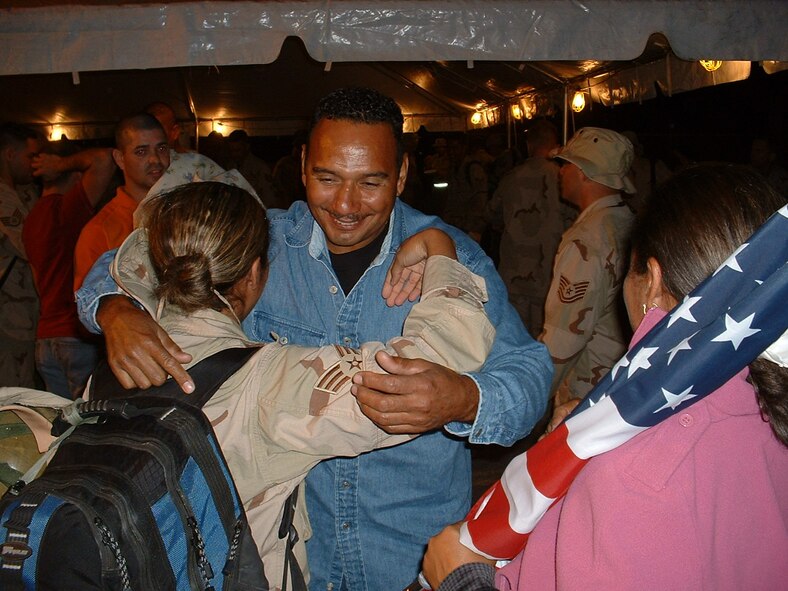 Senior Airman Carmen Martinez gets a hug from her father as she returns home from Balad Air Base, Iraq.  Martinez was deployed to Iraq as part of the 332nd Air Expeditionary Wing, in support of the Global War on Terror (U.S. Air Force Reserve Photo by Leo Castellano).