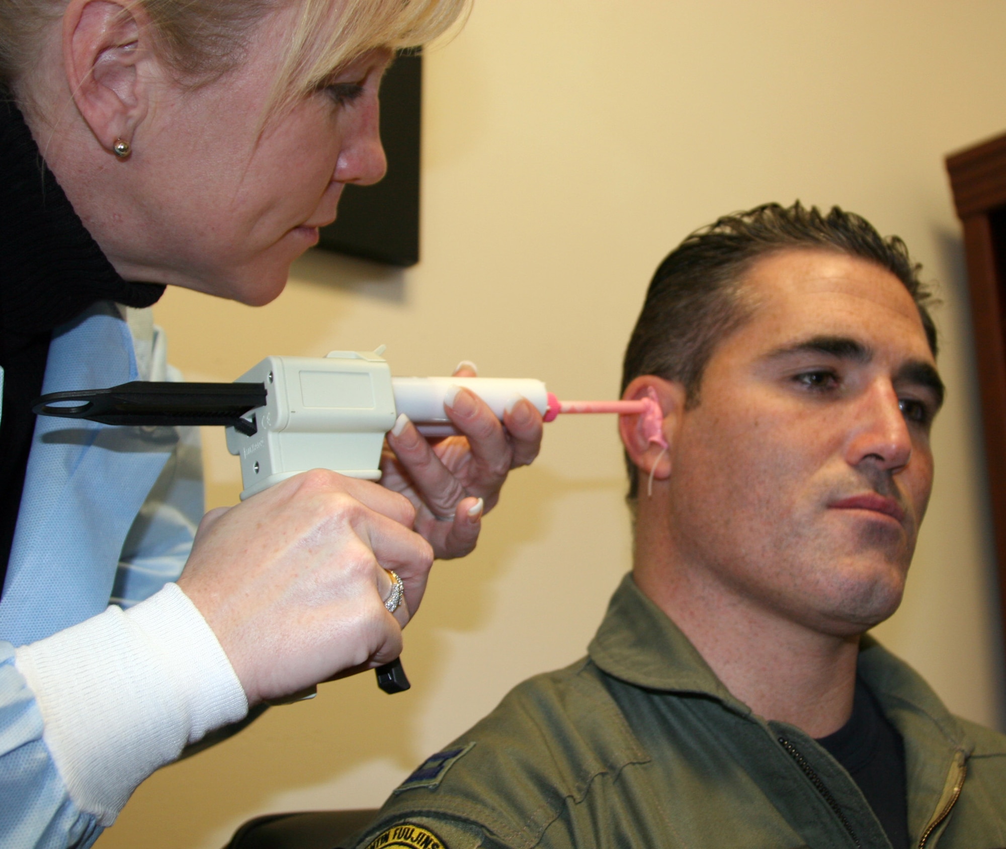 HILL AIR FORCE BASE, Utah -- Master Sgt. Crystal Martin makes a mold of Capt. Dax Cornelius' inner ear. The mold will be used to make a new earplug system for the 4th Fighter Squadron demonstration team member. Sergeant Martin is with the 75th Aerospace Medicine Squadron. (U.S. Air Force photo by Shad West)