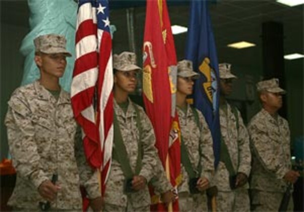 A mixed color guard represented both the Marine Corps and the Navy at the Navy?s 231st birthday, held in the main-side chow hall in Camp Taqaddum October 14.  During the birthday celebration, sailors observe such traditions as the cake cutting ceremony.  Navy Capt. Chuck Blankenship, a 57-year-old general surgeon with Taqaddum Surgical and a native of Texarcana, Tx. passed a piece of cake to Seaman Christopher L. Daniel, a 20-year-old native of Barnesville, Ga. and a corpsman with Military Police Company, CLR-15, 1st MLG.  When the oldest sailor passes the youngest sailor a piece of cake, it symbolizes the passing of tradition, said Senior Chief Ed Santa-Maria, Command Master Chief, 1st MLG.  It also symbolizes the passing of responsibility and the transference of values, so that the Navy remains the best in the world, said Santa-Maria, a 45-year-old native of Dededo, Guam.