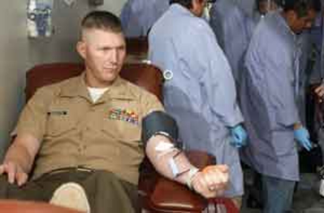 Capt. Brian W. McBrayer, depot protocol officer, donates one of 71 blood units collected at the depot?s Safety Fair and Blood Drive April 6.