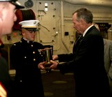 WASHINGTON - Petty Officer 1st Class Lawrence E. Pieper stands near the "Lone Sailor" statue following a Naval Medicine wreath-laying ceremony at the Navy Memorial June 15.  The wreath laying was conducted in memory of the lives of Naval Medicine officers and sailors lost in the line of duty.  The statue is a seven-foot tall bronze replica of a 2nd class petty officer in his mid-twenties who is standing watch over the granite sea, the map of the world and surrounding oceans.