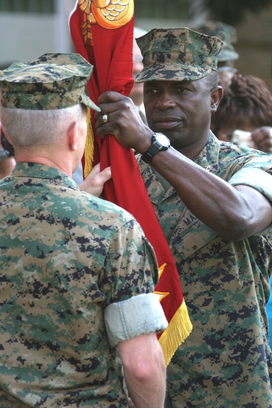 MARINE CORPS BASE CAMP LEJEUNE, N.C. (June 16, 2006)- Maj. Gen. Walter E. Gaskin receives the 2nd Marine Division colors from Maj. Gen. Richard A. Huck at their change of command ceremony here June 16. Gaskin was the commanding general of Marine Corps Recruiting Command before assuming command of the division. Huck was in command since Nov. 10, 2004 and led the division to Iraq for a year in February 2005.