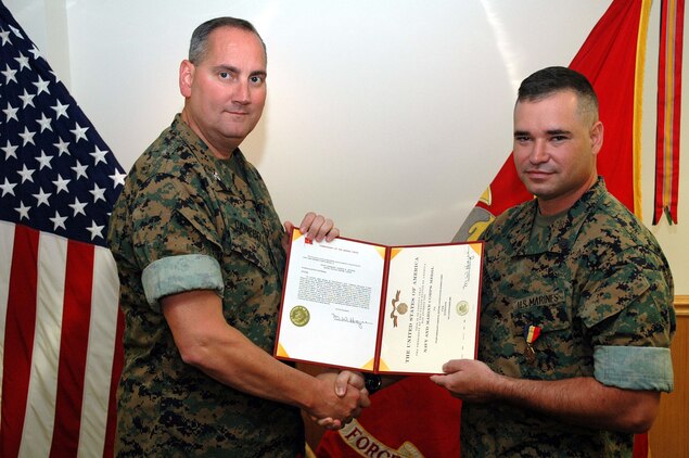 INDIAN HEAD, Md.--Staff Sgt. Carson B. Jeffers stands with Col. Michael F. Campbell, commanding officer of the Chemical Biological Incident Response Force (CBIRF) after being presented the Navy and Marine Corps Medal for heroism June 16.  The Navy and Marine Corps Medal is the highest peacetime award for heroism.  It may be awarded to any person serving in the U.S. Navy or the U.S. Marine Corps for acts of life-saving, or attempted lifesaving at the risk of one's own life.