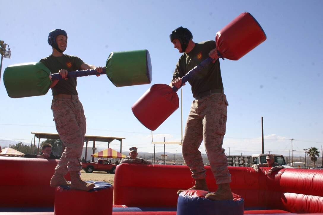 Lance Cpl. Ryan Stomberg, 1/7 Bravo Co., attempts to keep his balance after being hit by Pfc. Trevor Curtis, 1/7 Bravo Co., in a jousting match at the Combat Center.