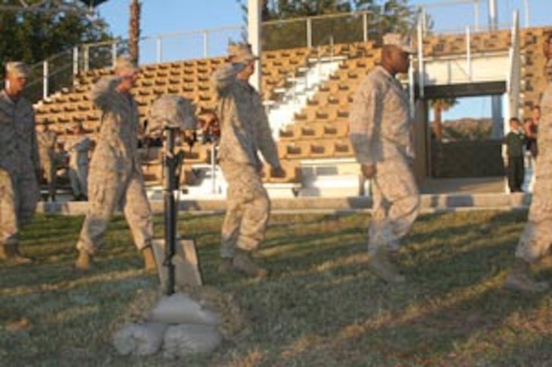 Marines from 1st Tank Battalion offer final respects to fallen Marine, Capt. Justin D. Peterson at a memorial held at Lance Cpl. Torrey L. Lance Cpl. Torrey L. Gray  Field Oct. 17.